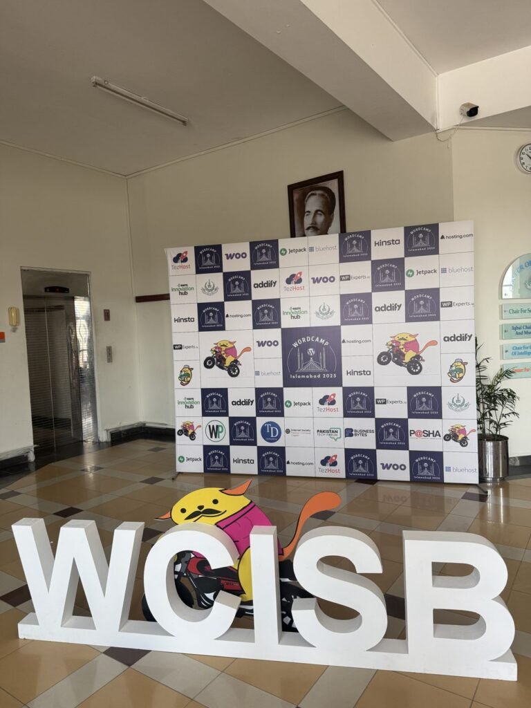 WCISB letters and the sponsor wall at WordCamp Islamabad 2025